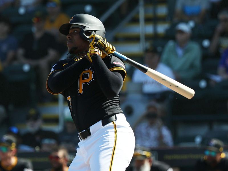 Feb 26, 2025; Bradenton, Florida, USA;  Pittsburgh Pirates third base Ke'Bryan Hayes (13) hits a sacrifice RBI during the fifth inning against the Baltimore Orioles at LECOM Park. Mandatory Credit: Kim Klement Neitzel-Imagn Images