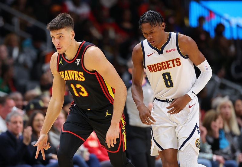 ATLANTA, GEORGIA - DECEMBER 11:  Bogdan Bogdanovic #13 of the Atlanta Hawks reacts after hitting a three-point basket against Peyton Watson #8 of the Denver Nuggets during the first quarter at State Farm Arena on December 11, 2023 in Atlanta, Georgia.  NOTE TO USER: User expressly acknowledges and agrees that, by downloading and/or using this photograph, user is consenting to the terms and conditions of the Getty Images License Agreement.  (Photo by Kevin C. Cox/Getty Images)