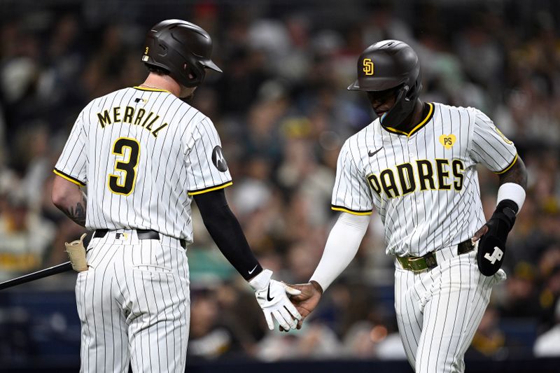 Jun 10, 2024; San Diego, California, USA; San Diego Padres left fielder Jurickson Profar (right) is congratulated by center fielder Jackson Merrill (3) after scoring a run against the Oakland Athletics during the seventh inning at Petco Park. Mandatory Credit: Orlando Ramirez-USA TODAY Sports