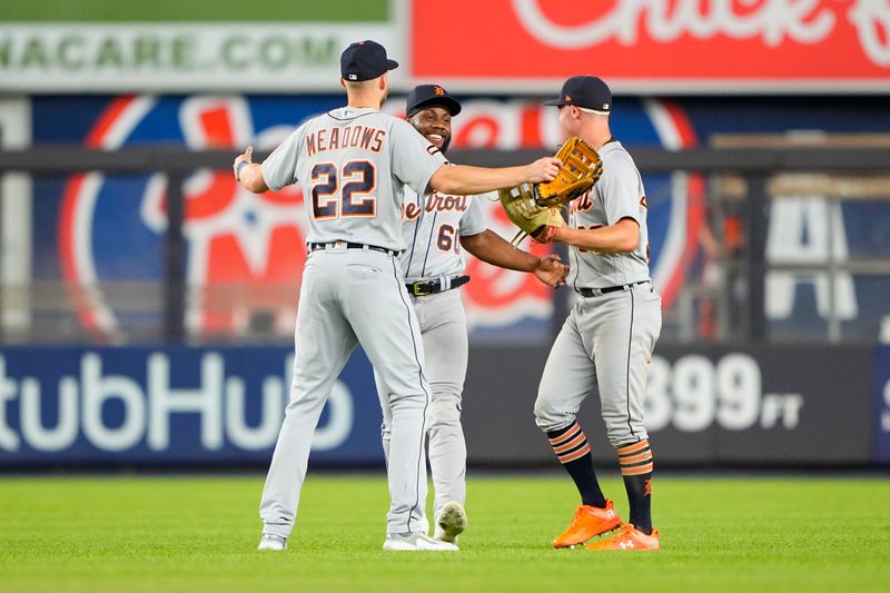 Sep 7, 2023; Bronx, New York, USA; Detroit Tigers left fielder Akil Baddoo (60) and center fielder Parker Meadows (22) and right fielder Kerry Carpenter (30) celebrate the victory against the New York Yankees after the ninth inning at Yankee Stadium. Mandatory Credit: Gregory Fisher-USA TODAY Sports