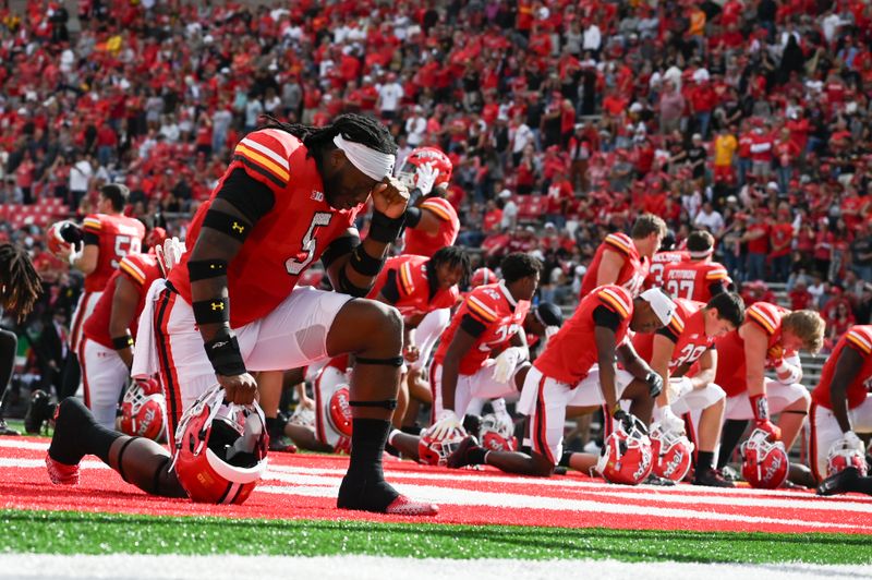 Sep 30, 2023; College Park, Maryland, USA; Maryland Terrapins defensive lineman Quashon Fuller (5) takes a moment with teammates before the game against the Indiana Hoosiers dat SECU Stadium. Mandatory Credit: Tommy Gilligan-USA TODAY Sports