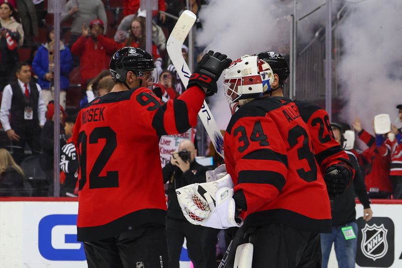 Mar 19, 2024; Newark, New Jersey, USA; The New Jersey Devils celebrate their win over the Pittsburgh Penguins at Prudential Center. Mandatory Credit: Ed Mulholland-USA TODAY Sports