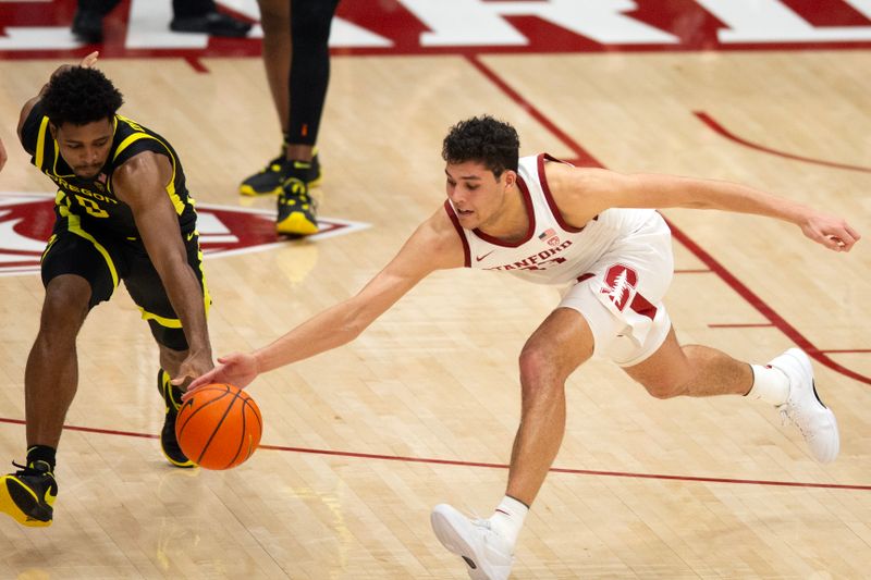 Feb 22, 2024; Stanford, California, USA; Oregon Ducks guard Kario Oquendo (left) and Stanford Cardinal forward Brandon Angel (23) vie for a loose ball during the second half at Maples Pavilion. Mandatory Credit: D. Ross Cameron-USA TODAY Sports