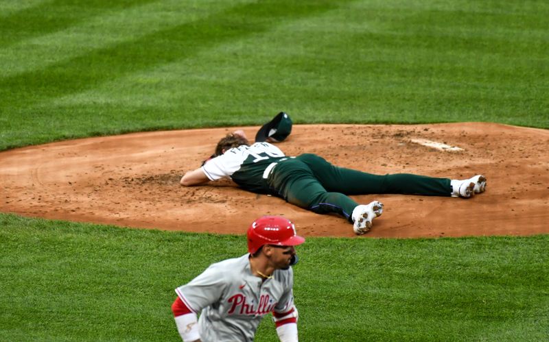 May 13, 2023; Denver, Colorado, USA; Colorado Rockies starting pitcher Ryan Feltner (18) lays on the mound after getting hit by a line drive by Philadelphia Phillies right fielder Nick Castellanos in the second inning at Coors Field. Mandatory Credit: John Leyba-USA TODAY Sports