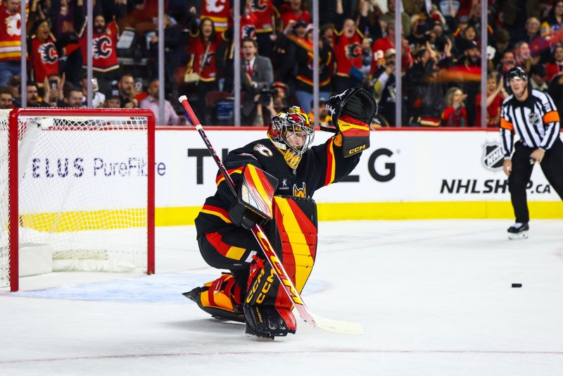 Oct 22, 2024; Calgary, Alberta, CAN; Calgary Flames goaltender Dustin Wolf (32) celebrates win after defeating the Pittsburgh Penguins during the shootout period at Scotiabank Saddledome. Mandatory Credit: Sergei Belski-Imagn Images