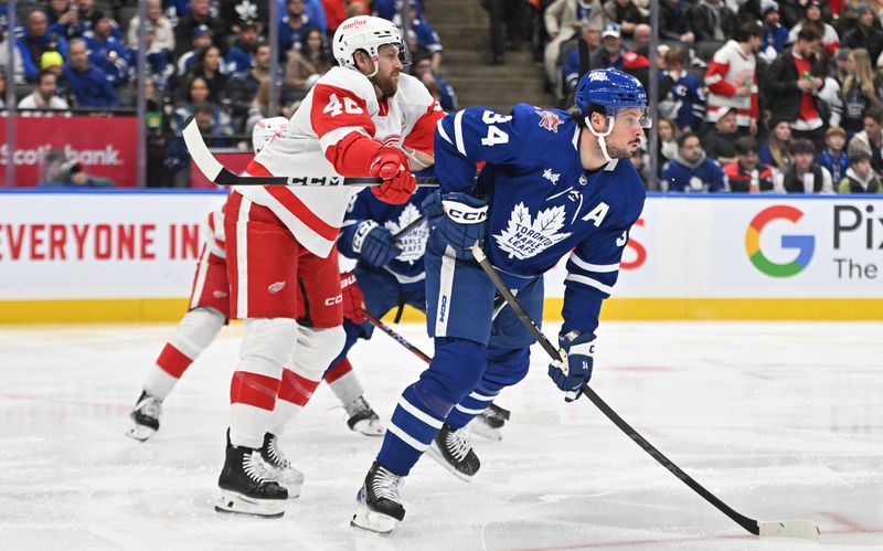 Jan 14, 2024; Toronto, Ontario, CAN;  Detroit Red Wings defenseman Jeff Petry (46) uses his stick to push away Toronto Maple Leafs forward Auston Matthews (34) in the first period at Scotiabank Arena. Mandatory Credit: Dan Hamilton-USA TODAY Sports