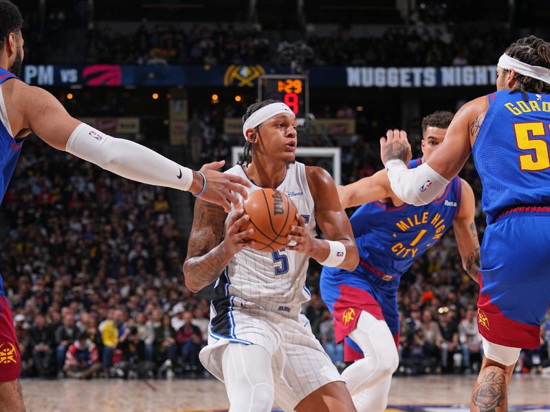 DENVER, CO - JANUARY 5: Paolo Banchero #5 of the Orlando Magic handles the ball during the game against the Denver Nuggets on January 5, 2024 at the Ball Arena in Denver, Colorado. NOTE TO USER: User expressly acknowledges and agrees that, by downloading and/or using this Photograph, user is consenting to the terms and conditions of the Getty Images License Agreement. Mandatory Copyright Notice: Copyright 2024 NBAE (Photo by Bart Young/NBAE via Getty Images)