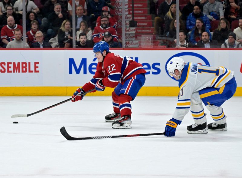 Feb 21, 2024; Montreal, Quebec, CAN; Montreal Canadiens forward Cole Caufield (22) plays the puck and Buffalo Sabres defenseman Henri Jokiharju (10) defends during the third period at the Bell Centre. Mandatory Credit: Eric Bolte-USA TODAY Sports