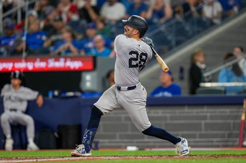 Jun 29, 2024; Toronto, Ontario, CAN; New York Yankees catcher Austin Wells (28) hits a home run against the Toronto Blue Jays during the ninth inning at Rogers Centre. Mandatory Credit: Kevin Sousa-USA TODAY Sports