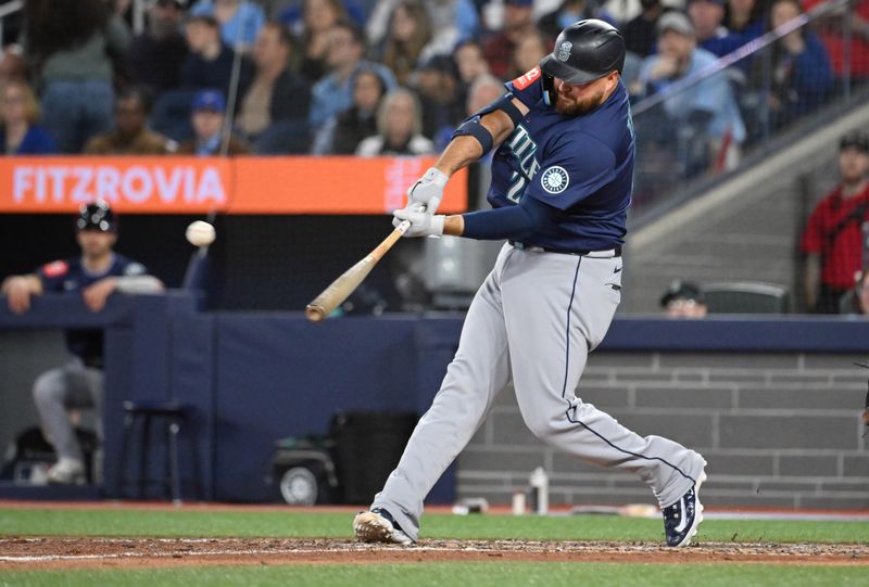 Apr 20, 2025; Toronto, Ontario, CAN;  Seattle Mariners first baseman Rowdy Tellez (23) hits a two run home run against the Toronto Blue Jays in the seventh inning at Rogers Centre. Mandatory Credit: Dan Hamilton-Imagn Images