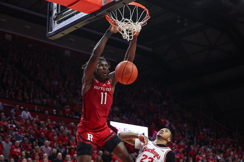 Jan 15, 2023; Piscataway, New Jersey, USA;  Rutgers Scarlet Knights center Clifford Omoruyi (11) dunks over Ohio State Buckeyes forward Zed Key (23) in overtime at Jersey Mike's Arena. Mandatory Credit: Vincent Carchietta-USA TODAY Sports