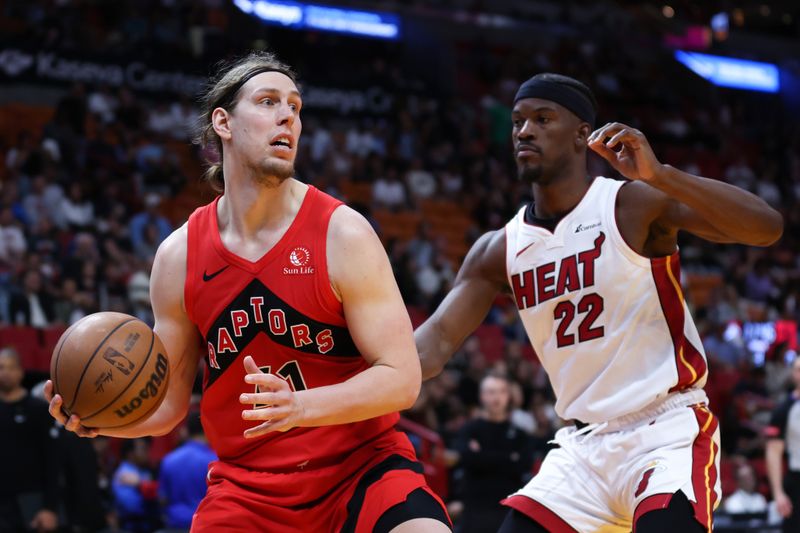 MIAMI, FLORIDA - APRIL 12: Kelly Olynyk #41 of the Toronto Raptors drives against Jimmy Butler #22 of the Miami Heat during the third quarter of the game at Kaseya Center on April 12, 2024 in Miami, Florida. NOTE TO USER: User expressly acknowledges and agrees that, by downloading and or using this photograph, User is consenting to the terms and conditions of the Getty Images License Agreement. (Photo by Megan Briggs/Getty Images)