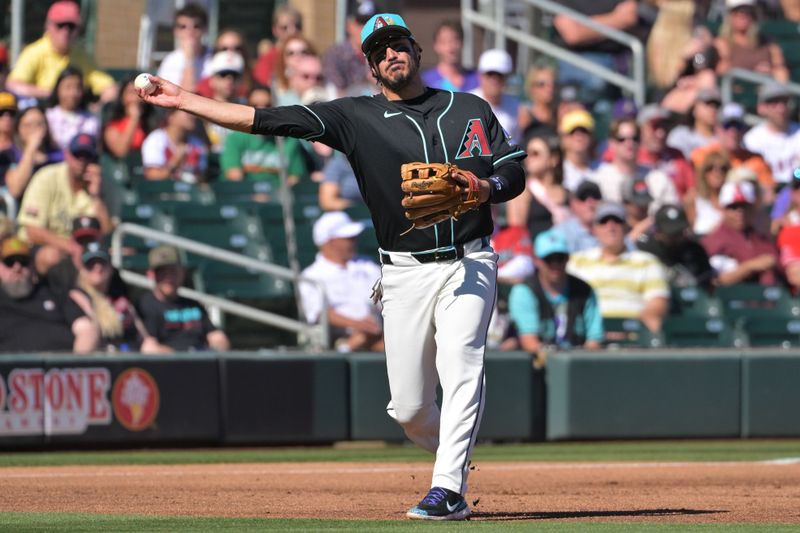 Feb 22, 2026; Salt River Pima-Maricopa, Arizona, USA; Arizona Diamondbacks third baseman Nolan Arenado (28) throws Los Angeles Angels outfielder Jose Siri (28) out at first in the third inning at Salt River Fields at Talking Stick. Mandatory Credit: Jayne Kamin-Oncea-Imagn Images