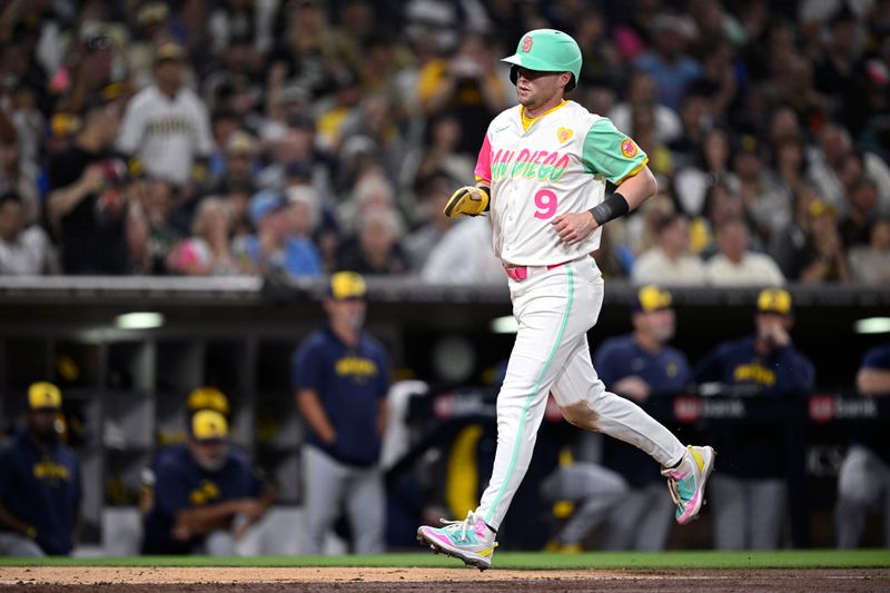 Jun 21, 2024; San Diego, California, USA; San Diego Padres second baseman Jake Cronenworth (9) advances home to score a run against the Milwaukee Brewers during the seventh inning at Petco Park. Mandatory Credit: Orlando Ramirez-USA TODAY Sports