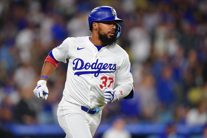 Sep 24, 2024; Los Angeles, California, USA; Los Angeles Dodgers left fielder Teoscar Hernández (37) reaches first on a single against the San Diego Padres during the first inning at Dodger Stadium. Mandatory Credit: Gary A. Vasquez-Imagn Images