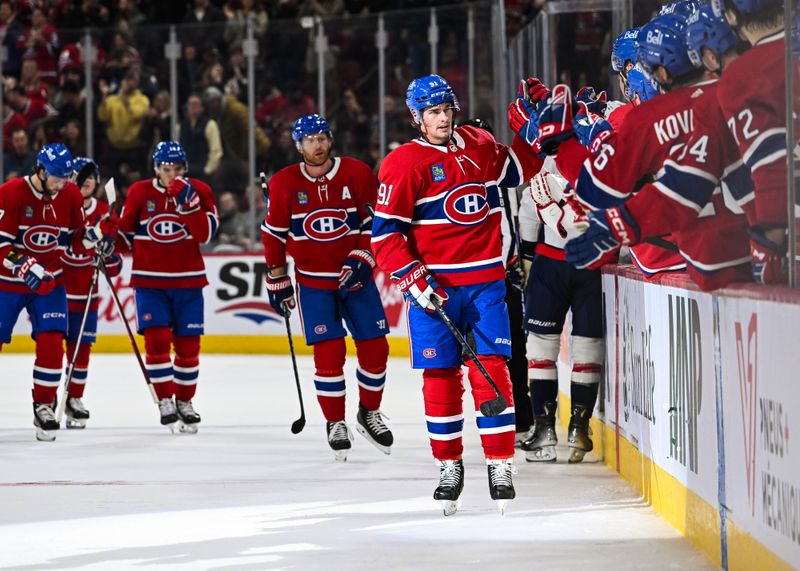 Oct 21, 2023; Montreal, Quebec, CAN; Montreal Canadiens center Sean Monahan (91) celebrates his goal against the Washington Capitals with his teammates at the bench during the first period at Bell Centre. Mandatory Credit: David Kirouac-USA TODAY Sports