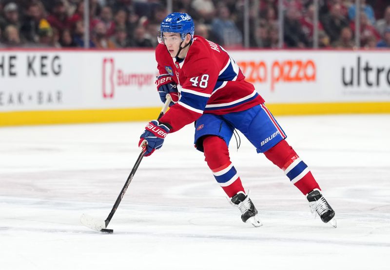 Dec 9, 2025; Montreal, Quebec, CAN; Montreal Canadiens defenseman Lane Hutson (48) plays the puck during the second period of the game against the Tampa Bay Lightning at the Bell Centre. Mandatory Credit: Eric Bolte-Imagn Images
