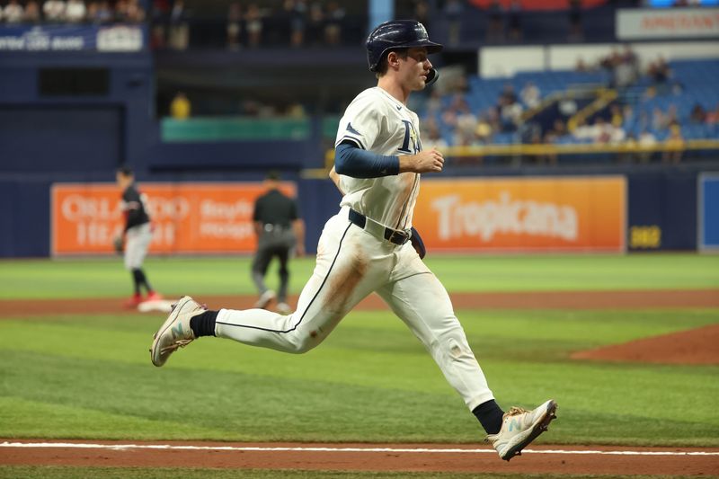 Sep 4, 2024; St. Petersburg, Florida, USA;  Tampa Bay Rays outfielder Jonny DeLuca (21) runs home to score a run against the Minnesota Twins during the fourth inning at Tropicana Field. Mandatory Credit: Kim Klement Neitzel-Imagn Images