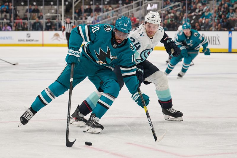 Jan 30, 2024; San Jose, California, USA; San Jose Sharks left wing Anthony Duclair (10) plays the puck against Seattle Kraken defenseman Jamie Oleksiak (24) during the second period at SAP Center at San Jose. Mandatory Credit: Robert Edwards-USA TODAY Sports