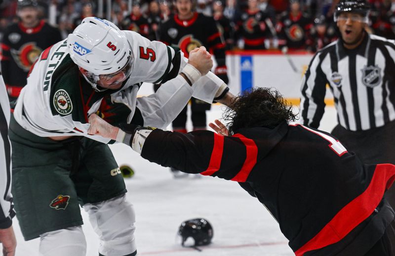 Nov 18, 2023; Stockholm, SWE; Minnesota Wild defenseman Jake Middleton (5) fights with Ottawa Senators center Zack MacEwen (17) during a Global Series NHL hockey game at Avicii Arena. Mandatory Credit: Per Haljestam-USA TODAY Sports