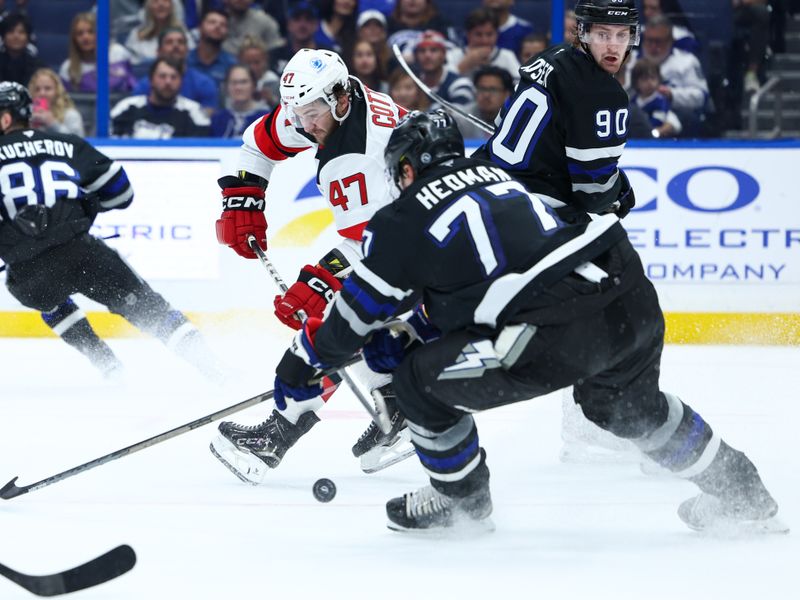 Nov 16, 2024; Tampa, Florida, USA; New Jersey Devils center Paul Cotter (47) controls the puck against the Tampa Bay Lightning in the second period at Amalie Arena. Mandatory Credit: Nathan Ray Seebeck-Imagn Images