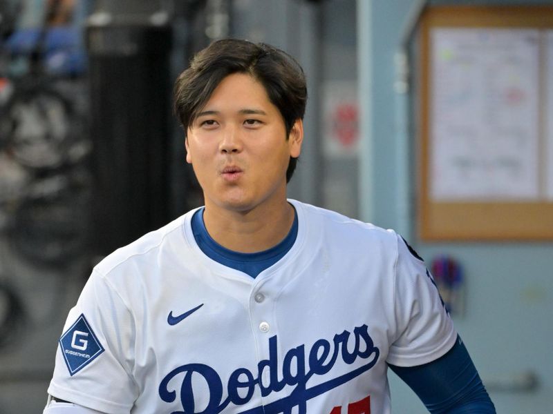Oct 1, 2025; Los Angeles, California, USA; Los Angeles Dodgers designated hitter Shohei Ohtani (17) looks on from the dugout prior to game two of the Wildcard round against the Cincinnati Reds for the 2025 MLB playoffs at Dodger Stadium. Mandatory Credit: Jayne Kamin-Oncea-Imagn Images
