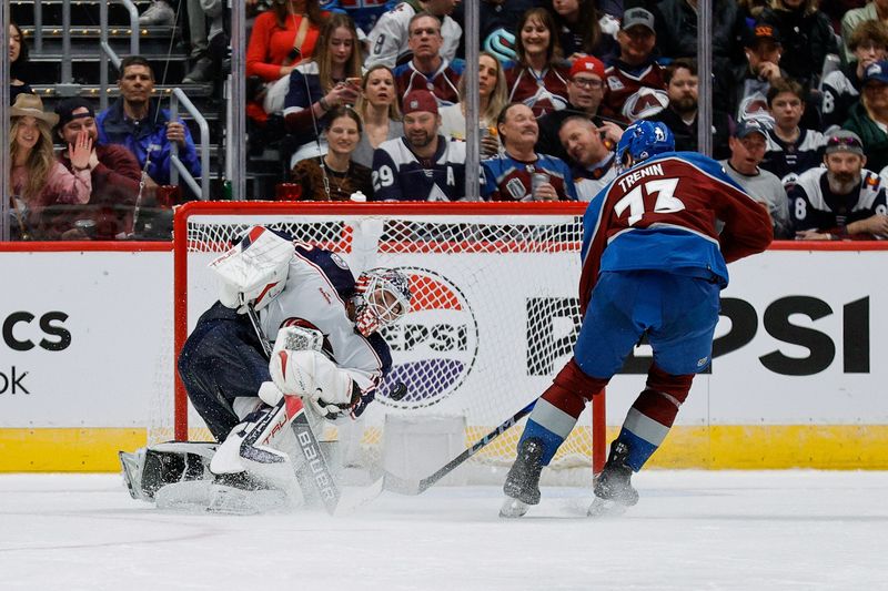 Mar 22, 2024; Denver, Colorado, USA; Columbus Blue Jackets goaltender Elvis Merzlikins (90) clears the puck against Colorado Avalanche center Yakov Trenin (73) in the third period at Ball Arena. Mandatory Credit: Isaiah J. Downing-USA TODAY Sports