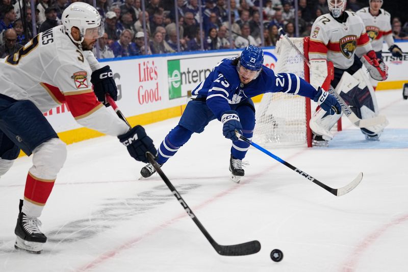 May 14, 2025; Toronto, Ontario, CAN; Florida Panthers defenseman Seth Jones (3) passes the puck as Toronto Maple Leafs forward Matthew Knies (23) closes in during the first period of game five of the second round of the 2025 Stanley Cup Playoffs at Scotiabank Arena. Mandatory Credit: John E. Sokolowski-Imagn Images