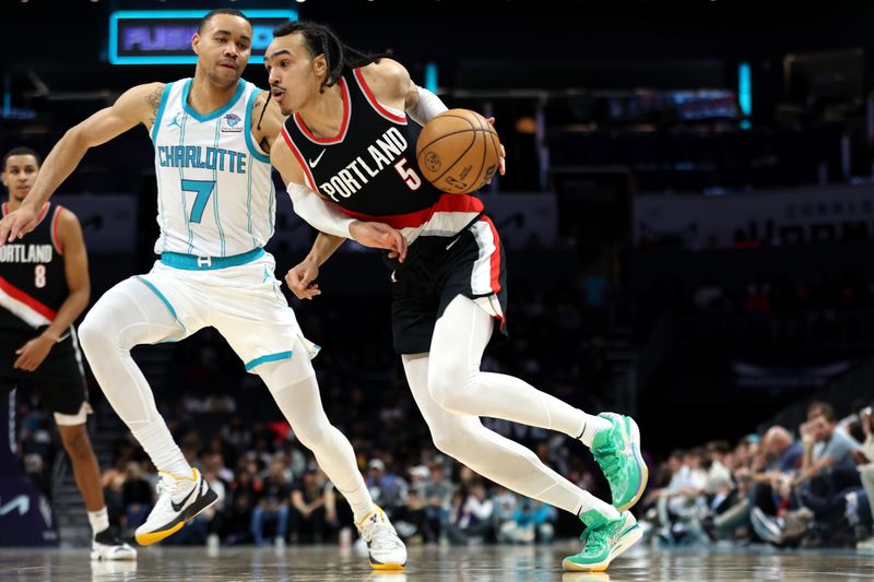 CHARLOTTE, NORTH CAROLINA - APRIL 03: Dalano Banton #5 of the Portland Trail Blazers drives to the basket against Bryce McGowens #7 of the Charlotte Hornets during the second half at Spectrum Center on April 03, 2024 in Charlotte, North Carolina. NOTE TO USER: User expressly acknowledges and agrees that, by downloading and or using this photograph, User is consenting to the terms and conditions of the Getty Images License Agreement. (Photo by David Jensen/Getty Images)