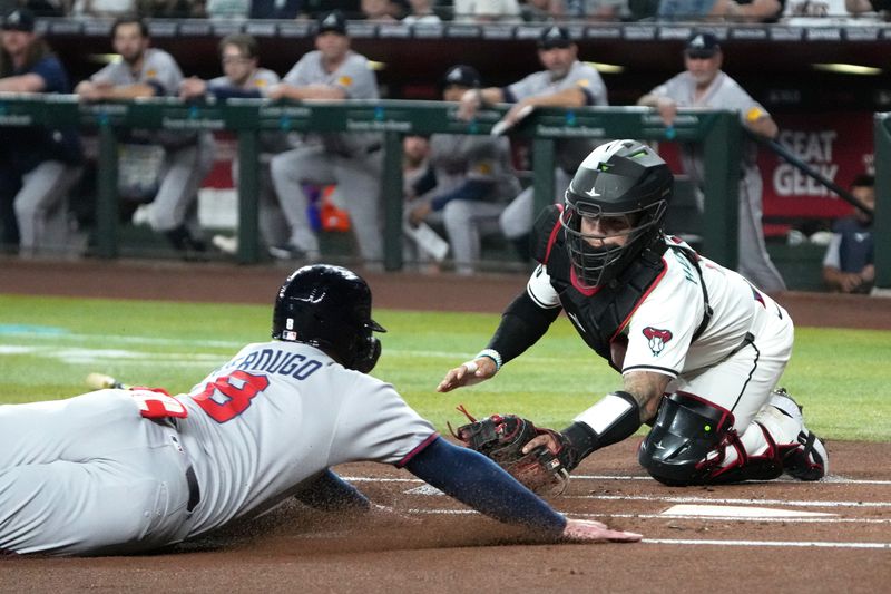 Apr 27, 2025; Phoenix, Arizona, USA; Arizona Diamondbacks catcher Jose Herrera (11) tags out Atlanta Braves outfielder Alex Verdugo (8) trying to score in the first inning at Chase Field. Mandatory Credit: Rick Scuteri-Imagn Images
