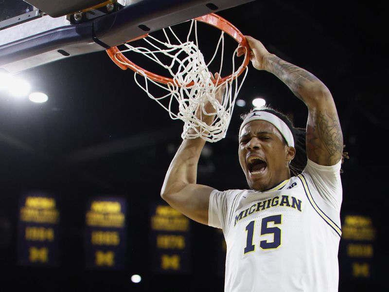 Feb 11, 2025; Ann Arbor, Michigan, USA;  Michigan Wolverines guard Rubin Jones (15) dunks in the first half against the Purdue Boilermakers at Crisler Center. Mandatory Credit: Rick Osentoski-Imagn Images