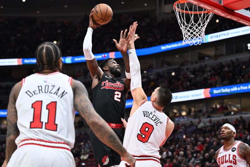 CHICAGO, ILLINOIS - MARCH 18:  Deandre Ayton #2 of the Portland Trail Blazers shoots over Nikola Vucevic #9 of the Chicago Bulls in the first half on March 18, 2024 at United Center in Chicago, Illinois.   NOTE TO USER: User expressly acknowledges and agrees that, by downloading and or using this photograph, User is consenting to the terms and conditions of the Getty Images License Agreement.  (Photo by Jamie Sabau/Getty Images)