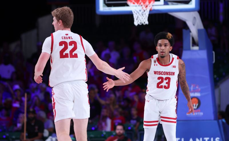 Nov 25, 2022; Paradise Island, BAHAMAS; Wisconsin Badgers guard Chucky Hepburn (23) celebrates with Wisconsin Badgers forward Steven Crowl (22) after scoring during the first half against the USC Trojans at Imperial Arena. Mandatory Credit: Kevin Jairaj-USA TODAY Sports