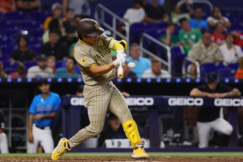 Aug 11, 2024; Miami, Florida, USA; San Diego Padres shortstop Ha-Seong Kim (7) hits a ground-rule double against the Miami Marlins during the ninth inning at loanDepot Park. Mandatory Credit: Sam Navarro-USA TODAY Sports