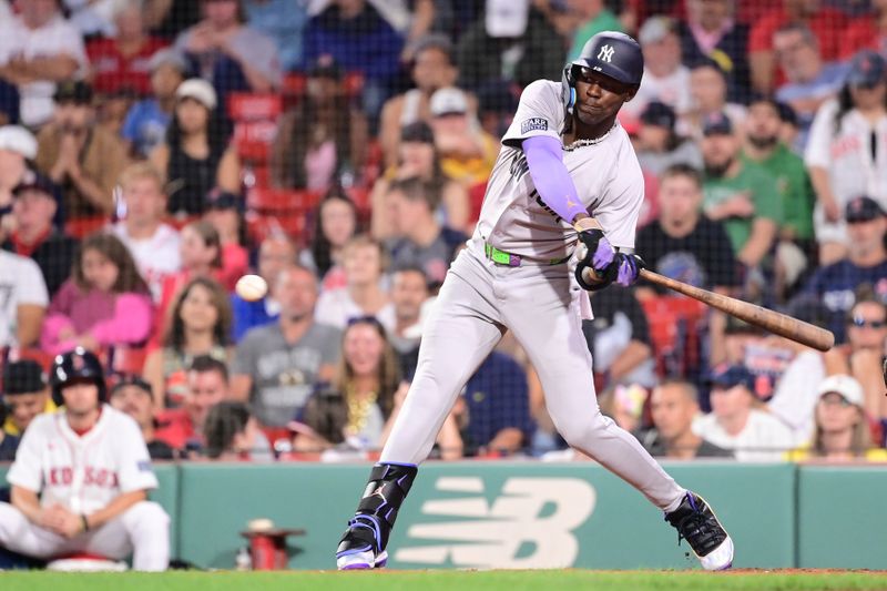 Jul 28, 2024; Boston, Massachusetts, USA; New York Yankees center fielder Jazz Chisholm Jr (13) hits a single against the Boston Red Sox during the ninth inning at Fenway Park. Mandatory Credit: Eric Canha-USA TODAY Sports