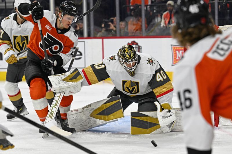 Dec 11, 2025; Philadelphia, Pennsylvania, USA; Vegas Golden Knights goaltender Akira Schmid (40) makes a save as Philadelphia Flyers center Christian Dvorak (22) looks for the rebound during the first period at Xfinity Mobile Arena. Mandatory Credit: Eric Hartline-Imagn Images