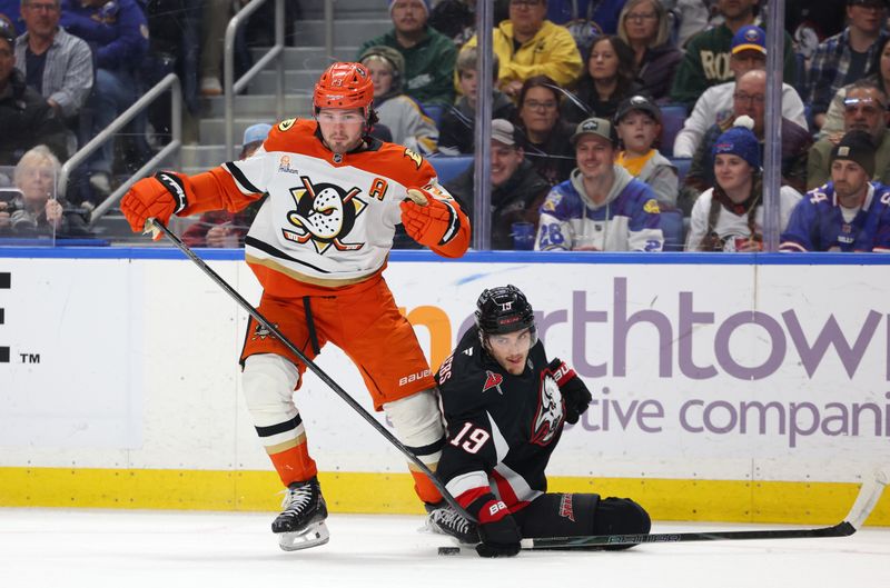 Jan 10, 2026; Buffalo, New York, USA;  Anaheim Ducks center Mason McTavish (23) and Buffalo Sabres center Peyton Krebs (19) look for the loose puck during the first period at KeyBank Center. Mandatory Credit: Timothy T. Ludwig-Imagn Images