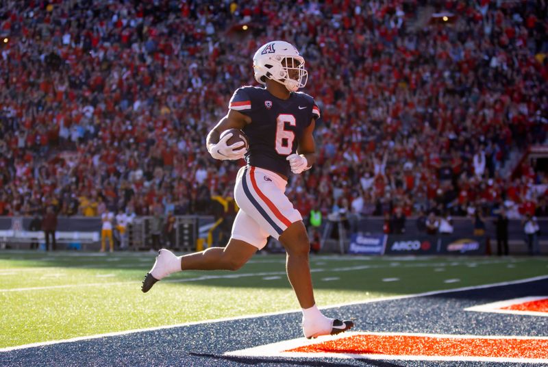 Nov 25, 2022; Tucson, Arizona, USA; Arizona Wildcats running back Michael Wiley (6) runs for a touchdown against the Arizona State Sun Devils in the second half of the Territorial Cup at Arizona Stadium. Mandatory Credit: Mark J. Rebilas-USA TODAY Sports