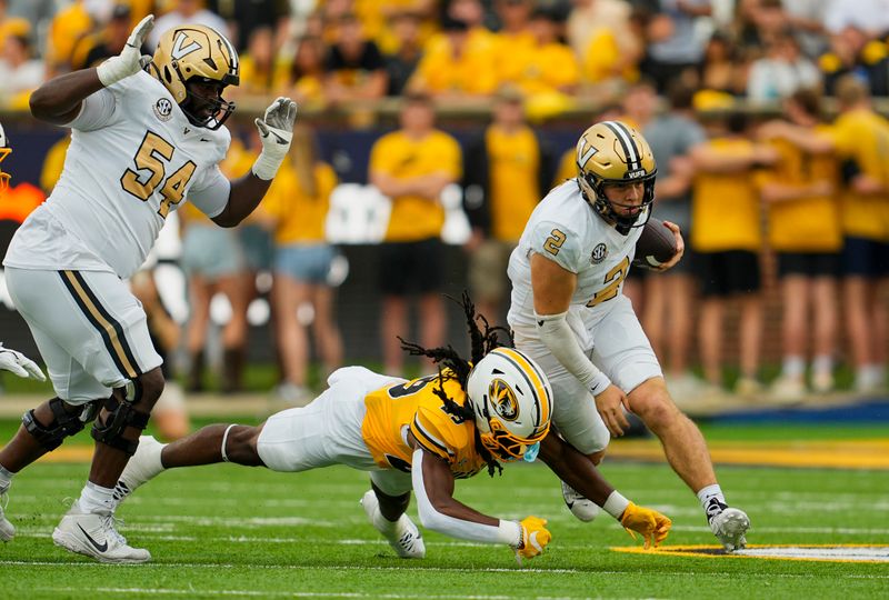 Sep 21, 2024; Columbia, Missouri, USA; Vanderbilt Commodores quarterback Diego Pavia (2) runs the ball against Missouri Tigers linebacker Khalil Jacobs (29) at Faurot Field at Memorial Stadium. Mandatory Credit: Jay Biggerstaff-Imagn Images
