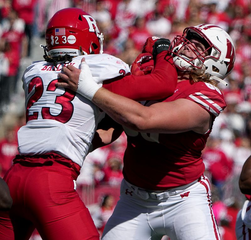 Oct 7, 2023; Madison, Wisconsin, USA; Wisconsin offensive lineman Joe Huber (60) blocks Rutgers defensive lineman Wesley Bailey (23) during the second quarter at Camp Randall Stadium. Mandatory Credit: Mark Hoffman-USA TODAY Sports