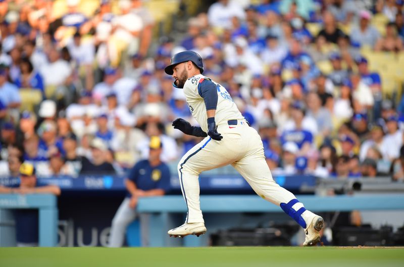 Jul 19, 2025; Los Angeles, California, USA; Los Angeles Dodgers left fielder Michael Conforto (23) hits a single during the second inning against the Milwaukee Brewers at Dodger Stadium. Mandatory Credit: Gary A. Vasquez-Imagn Images