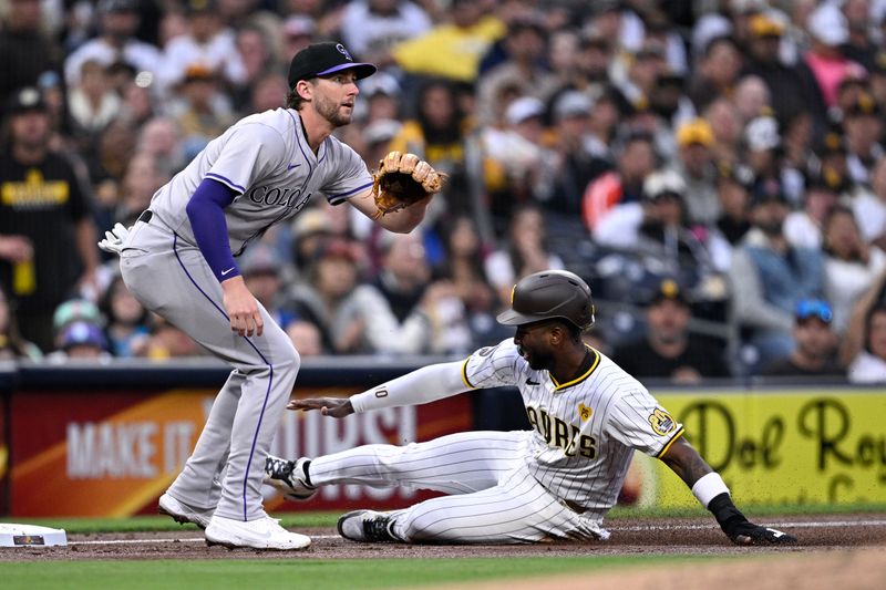 May 13, 2024; San Diego, California, USA; San Diego Padres left fielder Jurickson Profar (10) slides into third base ahead of the throw to Colorado Rockies third baseman Ryan McMahon (24) during the second inning at Petco Park. Mandatory Credit: Orlando Ramirez-USA TODAY Sports