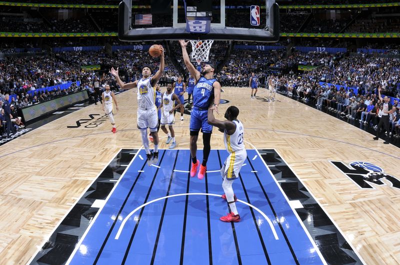 ORLANDO, FL - MARCH 27: Trayce Jackson-Davis #32 of the Golden State Warriors  rebounds the ball during the game against the Orlando Magic on March 27, 2024 at Amway Center in Orlando, Florida. NOTE TO USER: User expressly acknowledges and agrees that, by downloading and or using this photograph, User is consenting to the terms and conditions of the Getty Images License Agreement. Mandatory Copyright Notice: Copyright 2024 NBAE (Photo by Fernando Medina/NBAE via Getty Images)