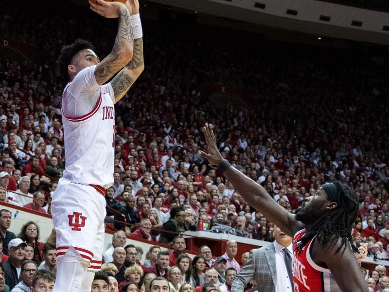 Jan 28, 2023; Bloomington, Indiana, USA; Indiana Hoosiers guard Jalen Hood-Schifino (1) shoots while Ohio State Buckeyes guard Isaac Likekele (13) defends in the first half at Simon Skjodt Assembly Hall. Mandatory Credit: Trevor Ruszkowski-USA TODAY Sports