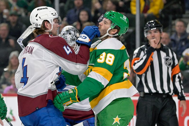 Nov 24, 2023; Saint Paul, Minnesota, USA; Colorado Avalanche defenseman Bowen Byram (4) sticks his hand in the face of Minnesota Wild forward Ryan Hartman (38) during the second period at Xcel Energy Center. Mandatory Credit: Nick Wosika-USA TODAY Sports