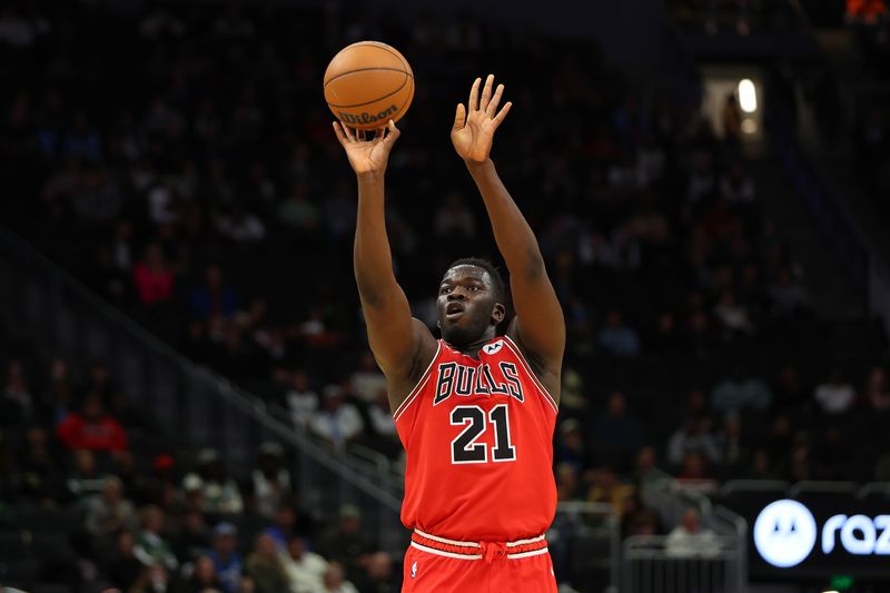 MILWAUKEE, WISCONSIN - OCTOBER 14: Adama Sanogo #21 of the Chicago Bulls takes a three point shot during the first half of a preseason game against the Milwaukee Bucks at Fiserv Forum on October 14, 2024 in Milwaukee, Wisconsin.  NOTE TO USER: User expressly acknowledges and agrees that, by downloading and or using this photograph, User is consenting to the terms and conditions of the Getty Images License Agreement. (Photo by Stacy Revere/Getty Images)