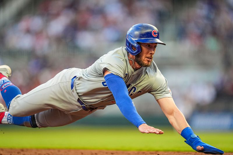 May 15, 2024; Cumberland, Georgia, USA; Chicago Cubs second baseman Miles Mastrobuoni (20) slides into third base against the Atlanta Braves during the third inning at Truist Park. Mandatory Credit: Dale Zanine-USA TODAY Sports