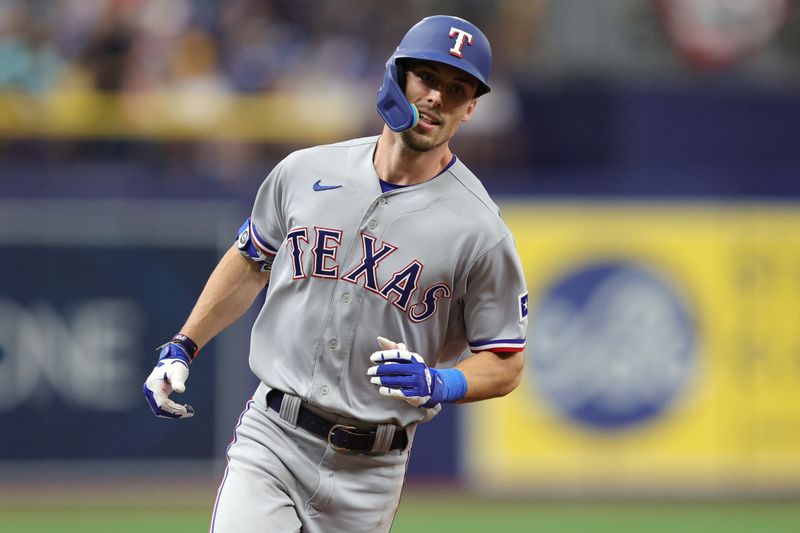 Oct 4, 2023; St. Petersburg, Florida, USA; Texas Rangers left fielder Evan Carter (32) runs around the bases after hitting a solo home run against the Tampa Bay Rays in the fourth inning during game two of the Wildcard series for the 2023 MLB playoffs at Tropicana Field. Mandatory Credit: Nathan Ray Seebeck-USA TODAY Sports