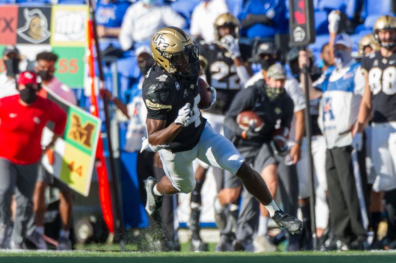 Oct 17, 2020; Memphis, Tennessee, USA; UCF Knights wide receiver Ryan O'Keefe (4) carries the ball against the Memphis Tigers during the first half  at Liberty Bowl Memorial Stadium. Mandatory Credit: Justin Ford-USA TODAY Sports