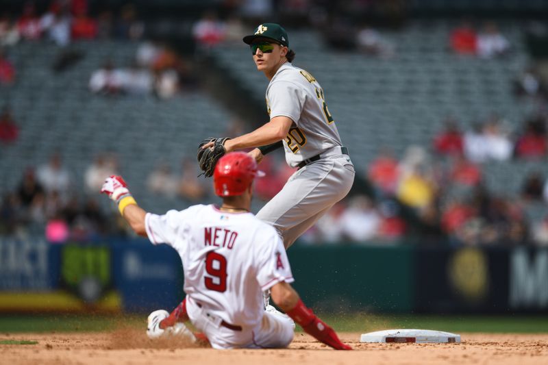 Oct 1, 2023; Anaheim, California, USA; Oakland Athletics second baseman Zack Gelof (20) forces out Los Angeles Angels shortstop Zach Neto (9) during the eighth inning at Angel Stadium. Mandatory Credit: Jonathan Hui-USA TODAY Sports